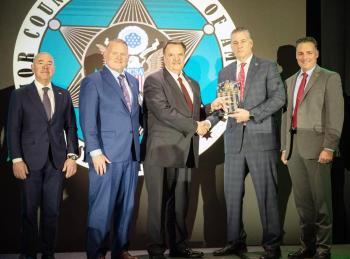 Sheriff Koutoujian stands with fourth dignitaries and is presented the MCSA Sheriff of the Year.