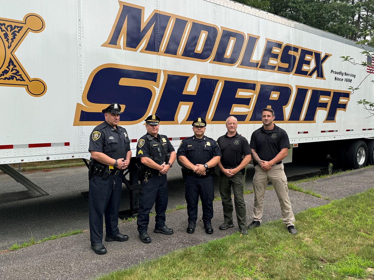 Shirley Police Chief Samuel Santiago and members of the Shirley PD and MSO outside the MTC,