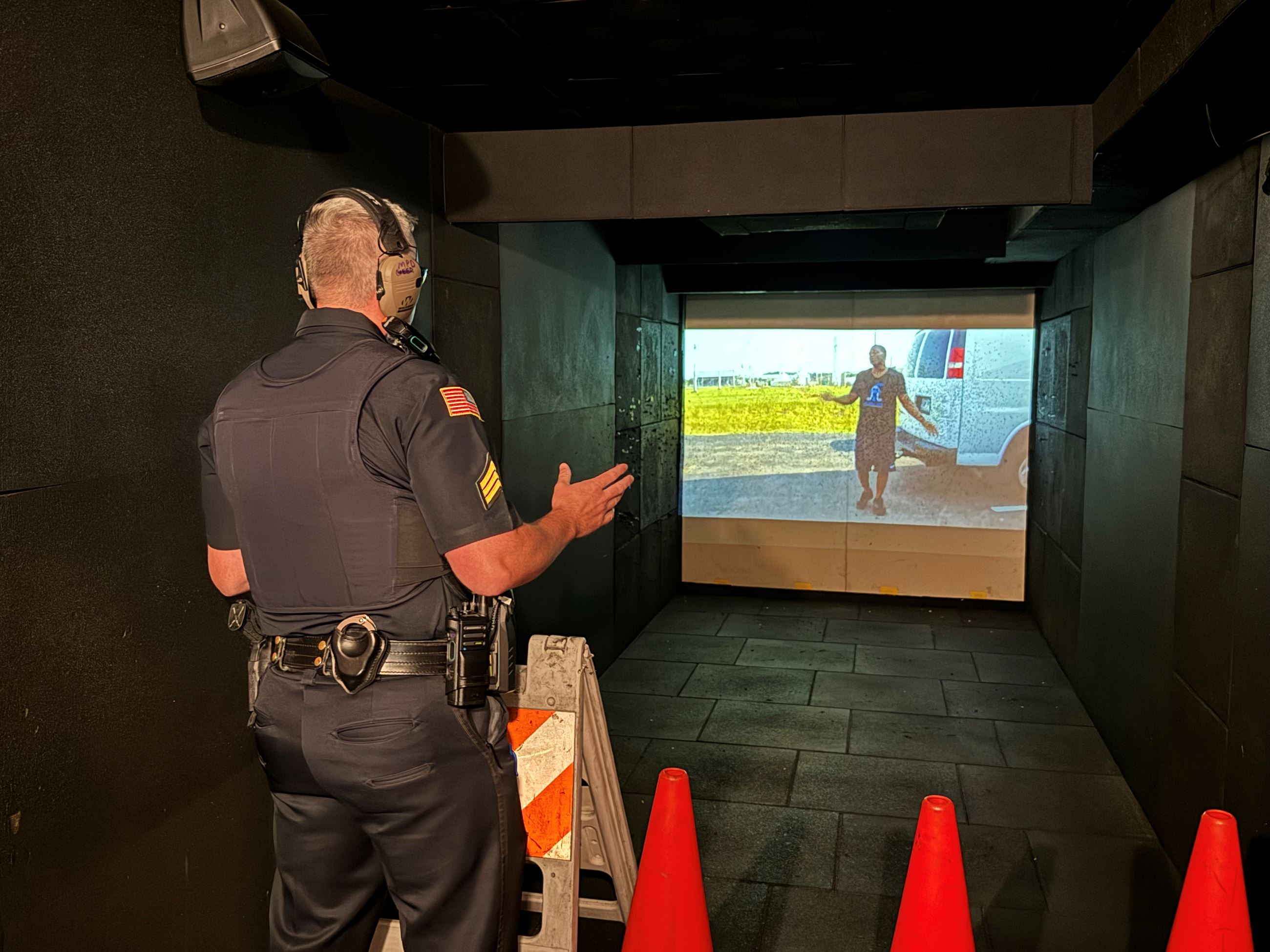 A Marlborough Police Sergeant participates in an interactive scenario on the Mobile Training Center.