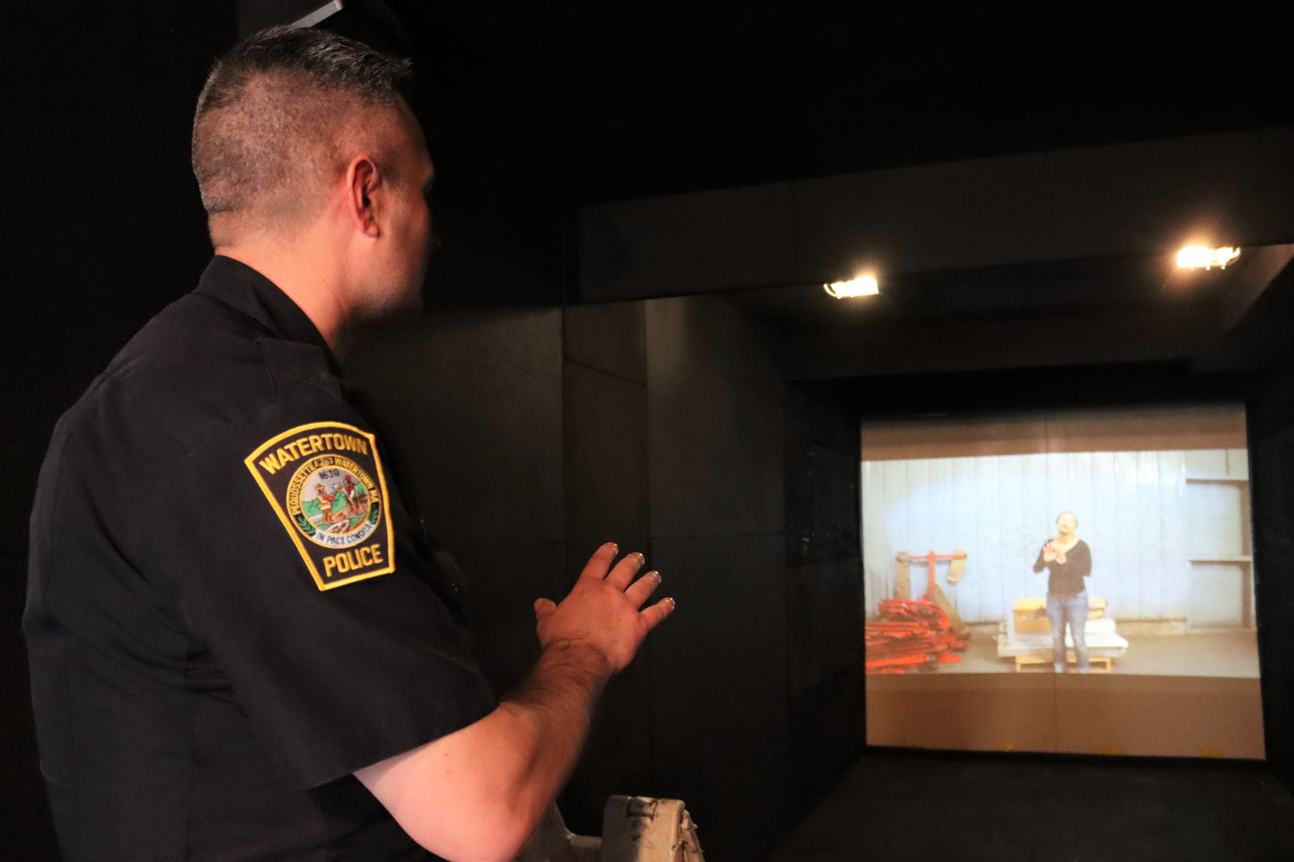 A Watertown police officer looks at a screen inside the Mobile Training Center.