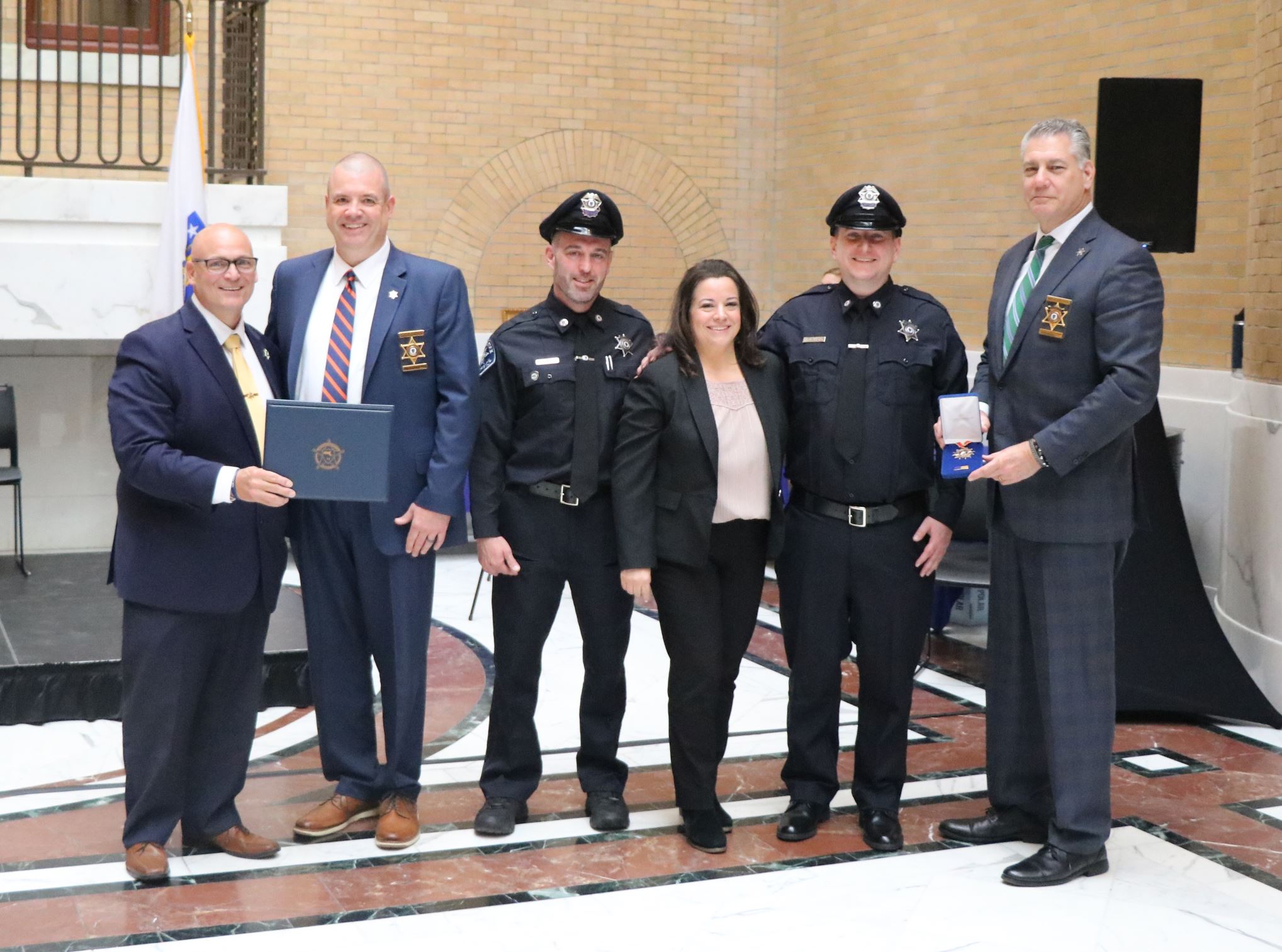 Sheriff Koutoujian and members of the OAR team accept an award at the State House.