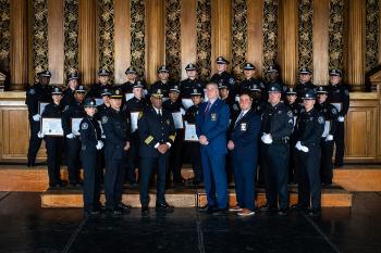 Members of the 47th Basic Training Academy post for photo with Sheriff Koutoujian, Harvard University Police Chief Victor Clay, Special Sheriff Cefalo and members of the training academy staff on stage.