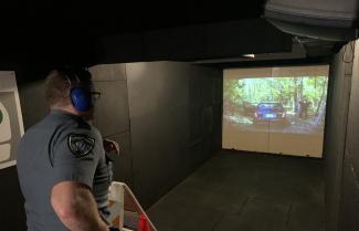 An Essex County Sheriff's Department Deputy goes through scenario-based training in the Middlesex Sheriff's Office Mobile Training Center (MTC).