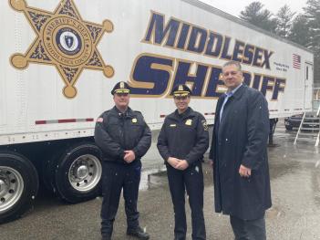 Hopkinton Police Chief Joseph Bennett (from left), Ashland Police Chief Cara Rossi and Middlesex Sheriff Peter J. Koutoujian stand outside the MSO's Mobile Training Center in Hopkinton on Tuesday, March 14, 2023.