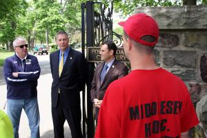 Malden Cemetery Superintendent James Cahill (from left), Middlesex Sheriff Peter J. Koutoujian and Malden Mayor Gary Christenson speak with a member of the Community Work Program (CWP) crew about clean up efforts at Malden's Forest Dale Cemetery.
