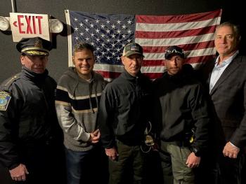 Malden Police Chief Glenn Cronin (from left), Malden Mayor Gary Christenson, Malden Police Lieutenant Rich Correale, Malden Police Officer Richard Doherty and Middlesex Sheriff Peter J. Koutoujian during a visit to the Middlesex Sheriff's Mobile Training Center on December 23, 2022.