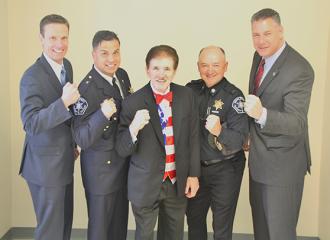 Special Sheriff Shawn Jenkins (from left), Assistant Deputy Superintendent Todd Ledbury, Lieutenant Dan Leone and Sheriff Peter J. Koutoujian pose with Rene Rancourt (center) prior to the Middlesex Sheriff’s Office Employee Recognition &amp; Award Ceremony in Chelmsford, Mass. on Wednesday, May 4, 2016.  For the fourth consecutive year, Rancourt performed the National Anthem to open the ceremony.