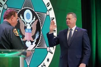 Middlesex Sheriff Peter J. Koutoujian (right) is sworn in as the new President of the Major County Sheriffs of America by outgoing President Grady Judd.