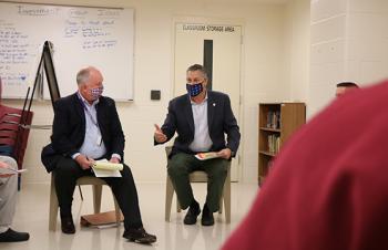 Project Citizen facilitator Ed O’Connell (from left) and Middlesex Sheriff Peter J. Koutoujian speak with program participants at the Middlesex Jail &amp; House of Correction on Friday, November 6, 2020.